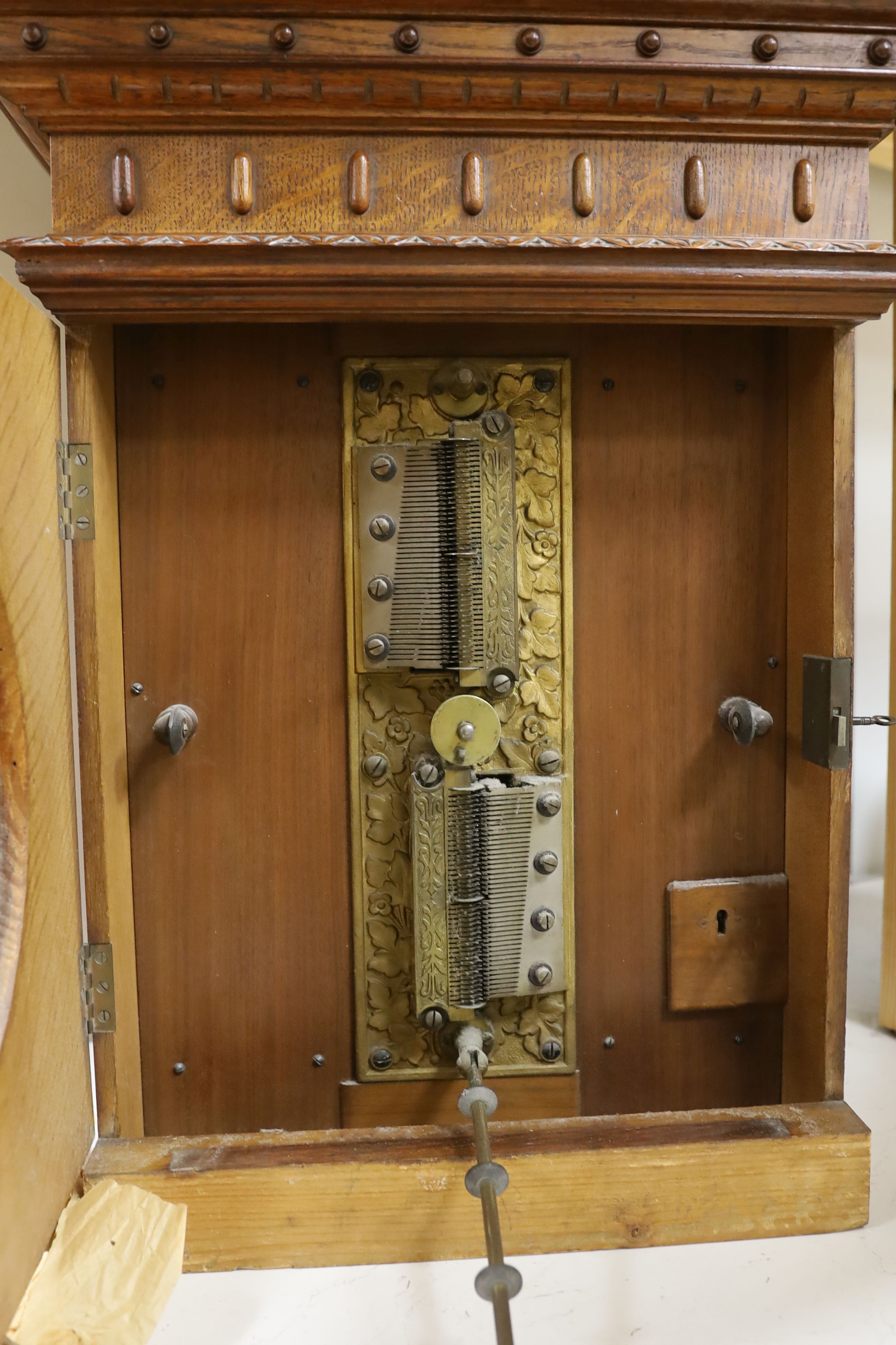 An oak cased penny operated polyphon (a.f.), with one 12 inch disc, dimensions; 76cm high, 52cm wide, 32cm deep